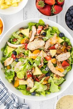 a white bowl filled with salad and fruit