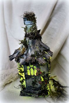 a bird house with moss growing on the roof