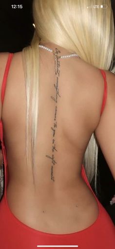 the back of a woman's body with tattoos on her upper and lower back