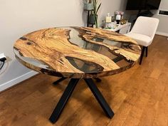 a wooden table sitting on top of a hard wood floor