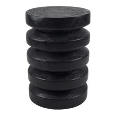 four black wooden stools stacked on top of each other