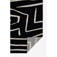 a black and white rug with an abstract design