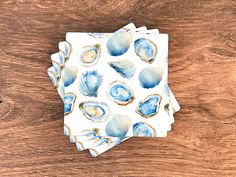 four coasters with blue and white shells on them