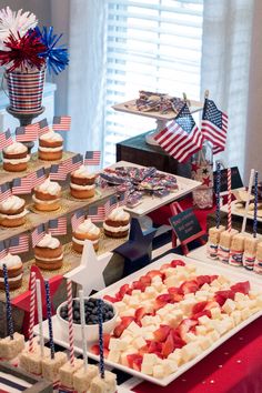 an american themed dessert table with cupcakes and cakes