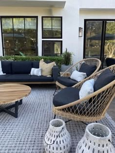 an outdoor living room with wicker furniture