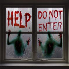 a window that has been decorated with red and green spray paint on it, which says help