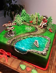 a birthday cake decorated with an image of a man riding a boat on the river