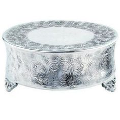 a round silver plate with ornate designs on it