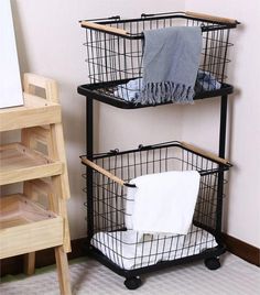 two black wire baskets with towels on them