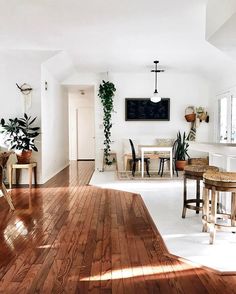 a living room filled with furniture and lots of wood on top of hard wood flooring