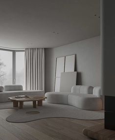 a living room with white furniture and large windows