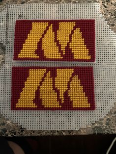 two cross stitch stickers with the letters minnesota and minnesota on them