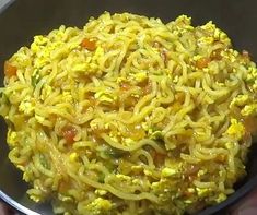 a bowl filled with noodles and vegetables on top of a table