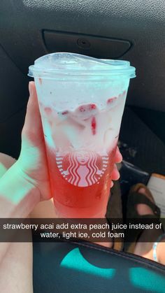 someone holding up a drink in their hand with the caption, strawberry acai extra peach juice instead of water, light ice, cold foam