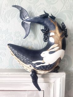 a decorative whale head sitting on top of a mantle