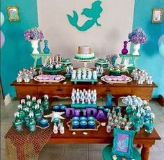 an under the sea themed birthday party with blue and purple decorations, cupcakes and cake