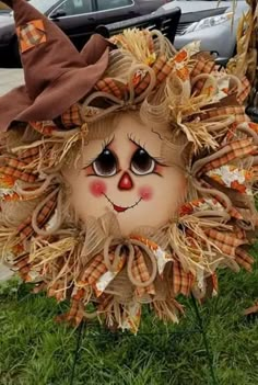 a scarecrow head sitting in the grass