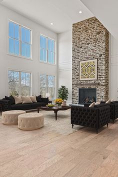 a living room with couches, chairs and a fireplace