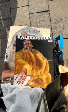 a magazine sitting on top of a pile of clothes