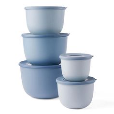 four blue and white bowls stacked on top of each other with lids in the middle