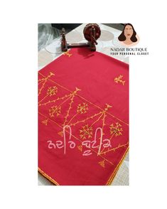 a red table cloth with gold designs on it