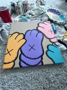 two cartoon characters painted on canvases next to some other items in the back ground