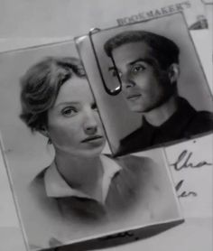 an old black and white photo of a man and woman with scissors in their hair