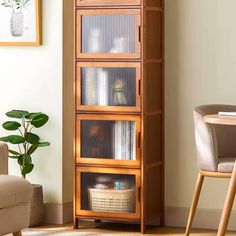 a living room with a chair, table and bookcase in it's corner