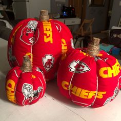 three red football themed pumpkins sitting on top of a table