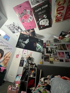 there are many posters hanging from the ceiling in this room with pictures on the walls