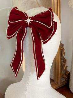 A beautiful red velvet hair bow with a gold crystal star centre. The red velvet bow is edged with a delicate row of cream pearls.  This hair bow is the perfect shade of deep red velvet for the festive season and would compliment your festive outfit wonderfully, wether it be a cosy Christmas jumper or your favourite party dress! *DETAILS*  * The bow is attached to a silver french Barrett hair clip * measurements - 1ycm across by 22cm * your bow will arrive in a gift box with luxury ribbon.  *DELI Red Velvet Hair, Clip For Hair, Hair Christmas, Velvet Hair Bow, Hair Bow Clip, Cosy Christmas, Star Hair, Gift Ideas For Her, Velvet Hair