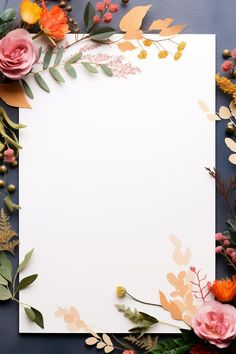 an empty paper surrounded by flowers and leaves