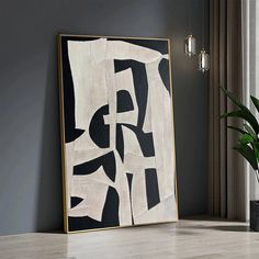 a large black and white abstract painting on the wall next to a potted plant