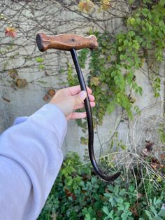 a person holding an old walking stick in their hand