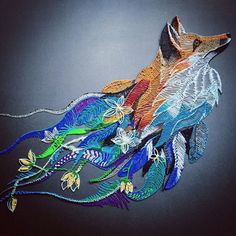 an image of a colorful animal made out of paper on a black background with blue, green, orange and yellow feathers