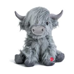 a stuffed animal that looks like a cow with horns and long hair, sitting on a white background