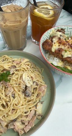 two plates of food and drinks on a table