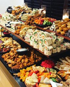 a buffet table filled with lots of different types of food