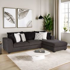 a living room filled with furniture and a white rug on top of a hard wood floor