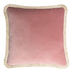 a pink and white pillow with fringe trim on the bottom, in front of a white background