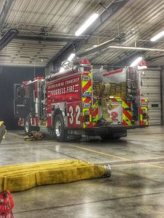 a fire truck parked in a garage next to a banana