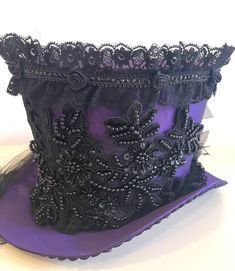 This is elegant Victorian gothic Hand made Black satin Top hat with purple/black back beautifully hand crafted feathers and bows black net bustle train. Top Hat with Black laces and 3D silk flowers and black pearls and jewels and sequences hand stitched. There is brass buckle at the side. Please refer to the photos. This is stunning Victorian Steampunk Handmade top hat made with lots of love. It is very well made, this hat is made of a Black satin type of fabric and the inside of the hat is has Vampire Wedding, Black Satin Top, Vampire Fashion, Bridal Party Accessories, Purple Gothic, Gothic Tops, Satin Noir, Black Pearls, Black Jewel