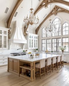 a large kitchen with an island and chandelier