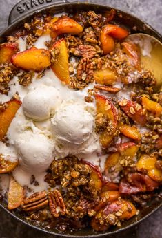 a skillet filled with fruit and ice cream