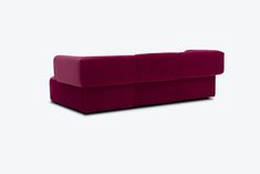 a purple couch sitting on top of a white floor