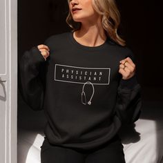 Our physician assistant medical specialty sweatshirt makes a great gift For a PA school graduation gift, white coat ceremony or physician assistant appreciation week. This simple yet striking design can be perfect surprise for that special physician assistant in your life or to treat yourself because you deserve it! SIZING INFORMATION: These sweatshirts are UNISEX. To get that oversized look, order two sizes bigger than your normal size. Since different manufacturers uniquely produce items, we very strongly recommend using the measurement chart provided in the picture section to make sure you order the correct size. Please do not forget to also check the length of the body and sleeves to see how the sizing works for your body type. PRODUCTION & SHIPPING: - Each sweatshirt is made to order. Pa School Graduation, Physician Associate, Physician Assistant Student, White Coat Ceremony Gift, White Coat Ceremony, Pa School, Physician Assistant, White Coat, Cricut Creations