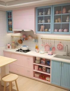 a kitchen with blue cabinets and pink counters