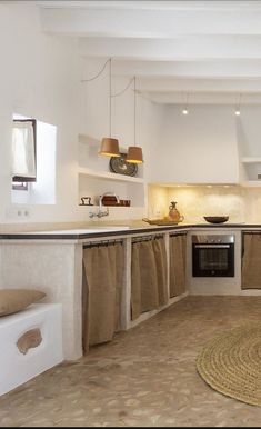 a kitchen with white walls and beige flooring