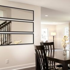 a dining room table and chairs in front of a fireplace