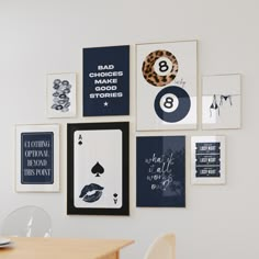 a wall with pictures, cards and other items hanging on it's side in a dining room